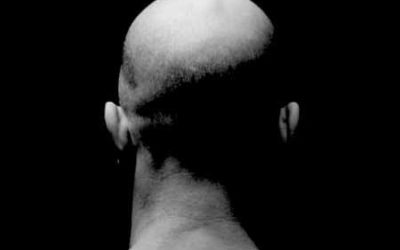 Who is the Bald Man in the chair?